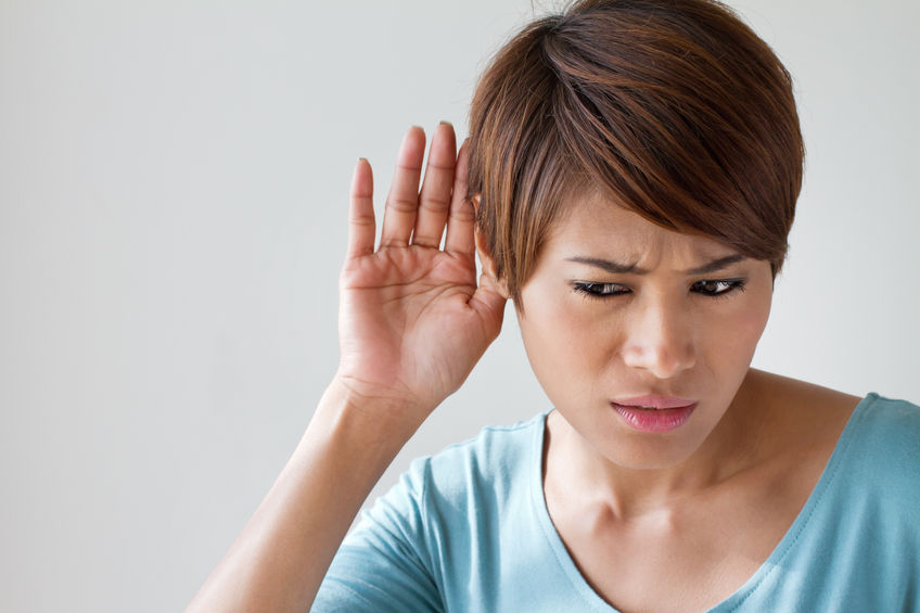 woman suffers from hearing impairment, hard of hearing, hearing loss