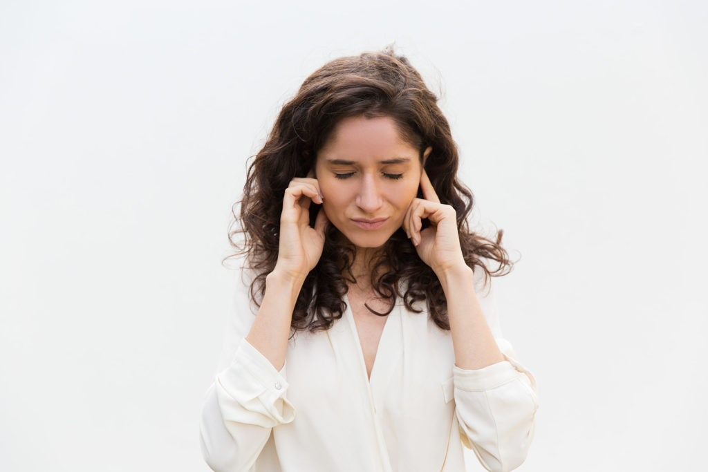 woman who is having a hard time hearing