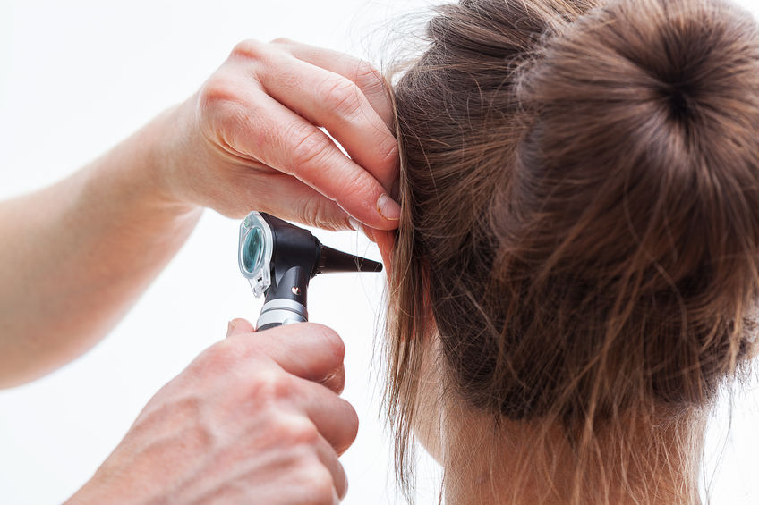 Ear examining with an otoscope for Tinnitus