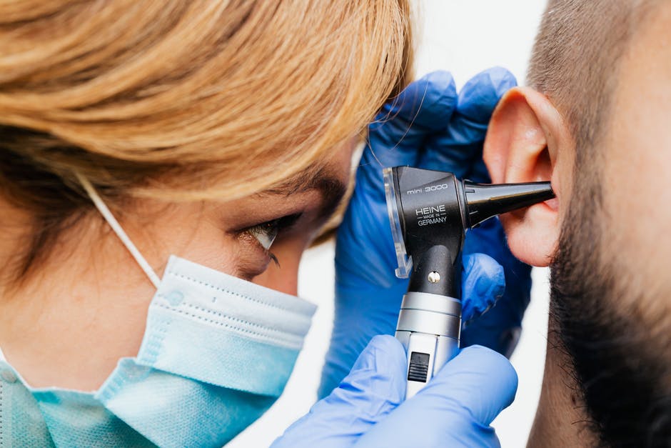 Audiologist examining a patient's ear
